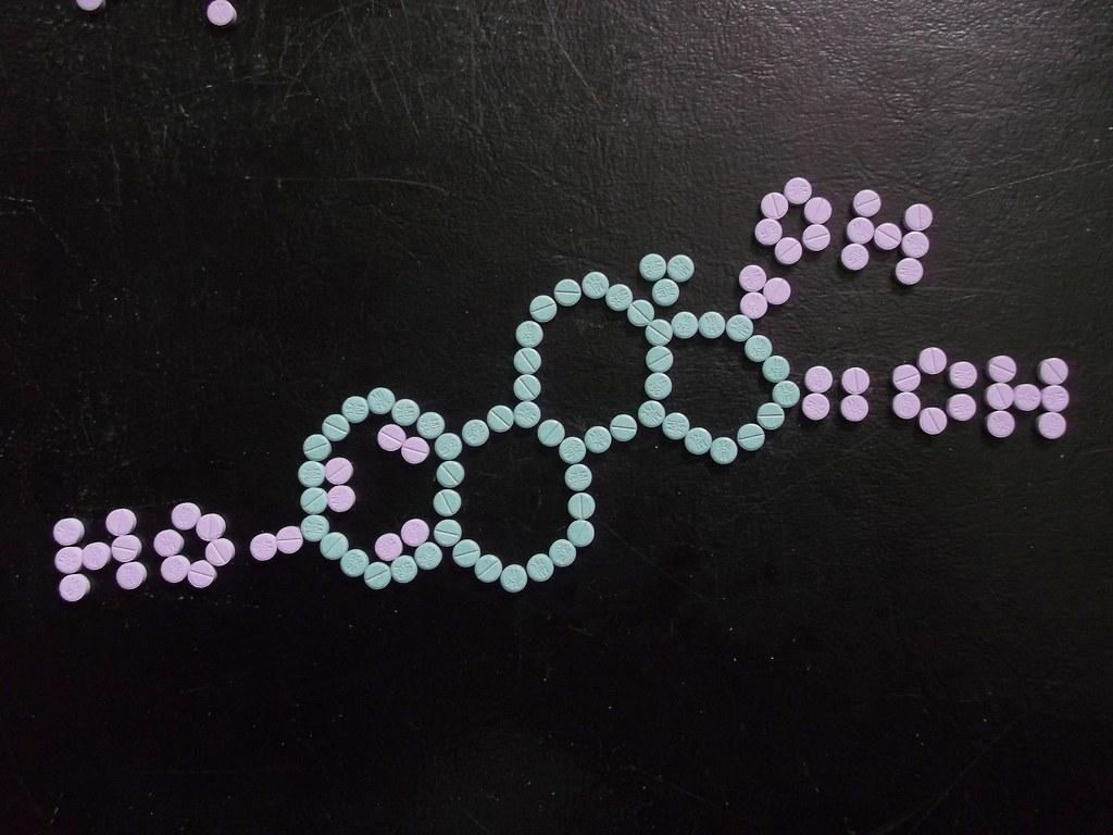 pills arranged to display a chemical structure
